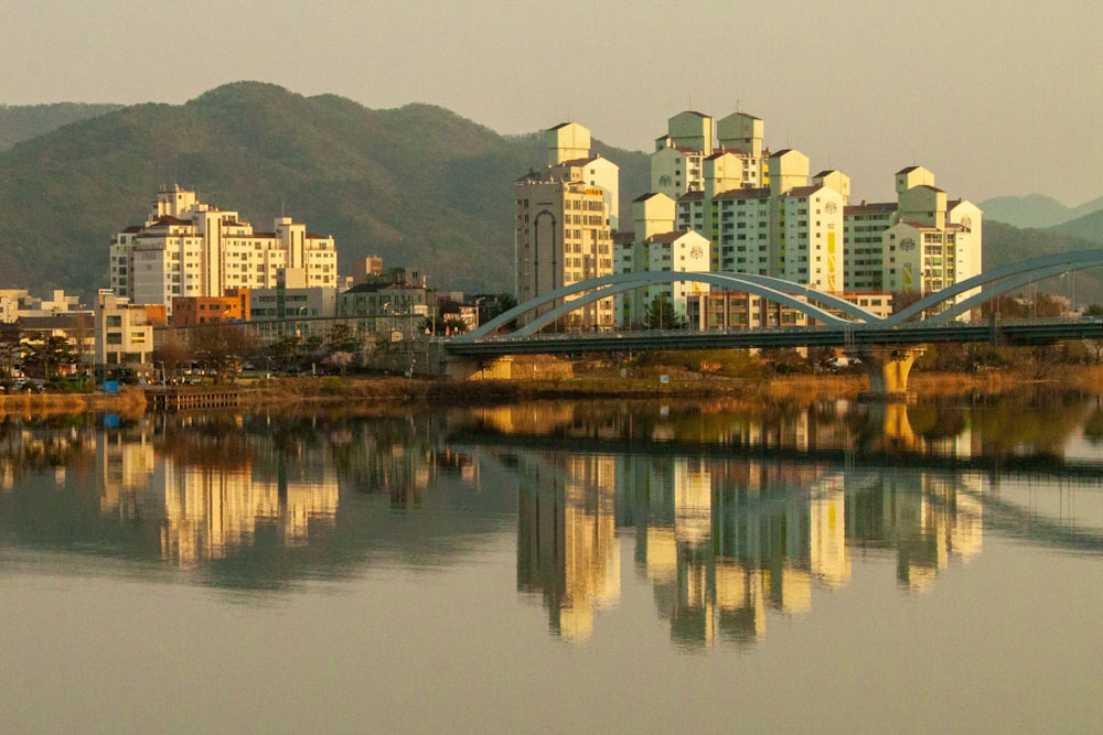 a large body of water with buildings in the background