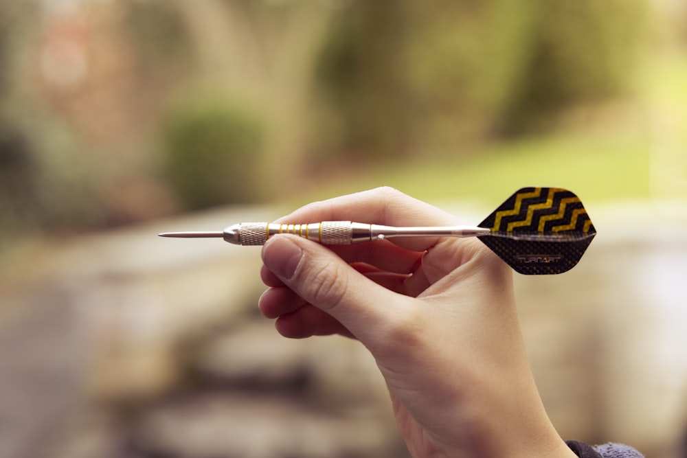 a person holding a small object in their hand