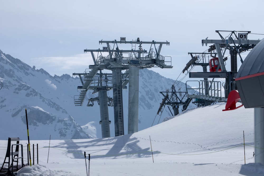 a ski lift going up a snowy mountain