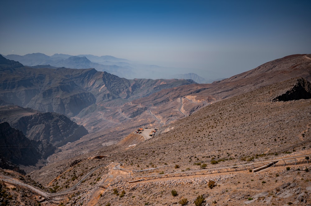 a view of a mountain range with a winding road in the foreground