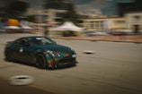 A fast-paced racing game screen with realistic cars zooming on a city track.