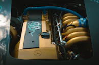 Under the hood view showing detailed engine maintenance on a Mercedes-Benz.
