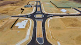 Wide shot of a newly built road with drainage systems integrated alongside.