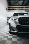 a white BMW X1 car is parked in a garage