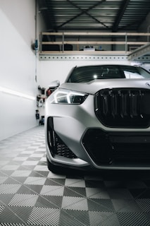 a white car is parked in a garage