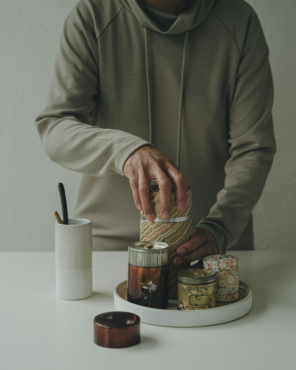 a man putting a jar on top of a table