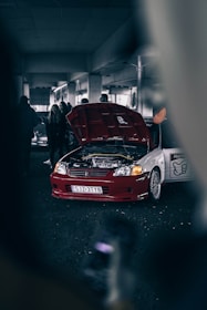 a car with its hood open in a garage