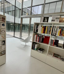 A modern, clean library space with philosophical books and a serene atmosphere.