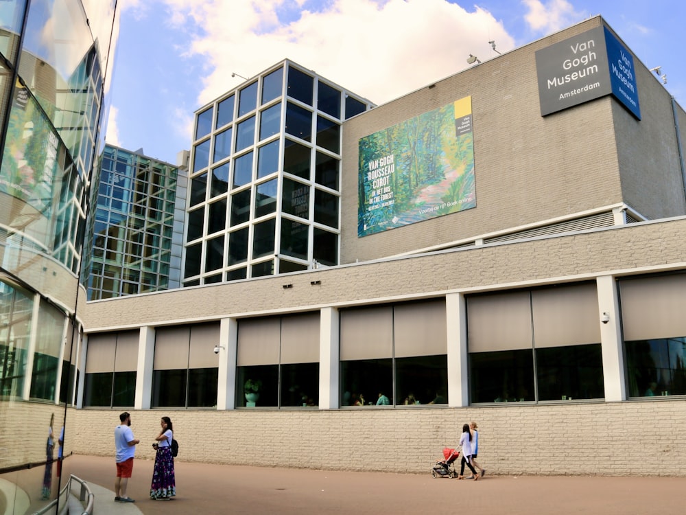 a group of people standing outside of a building