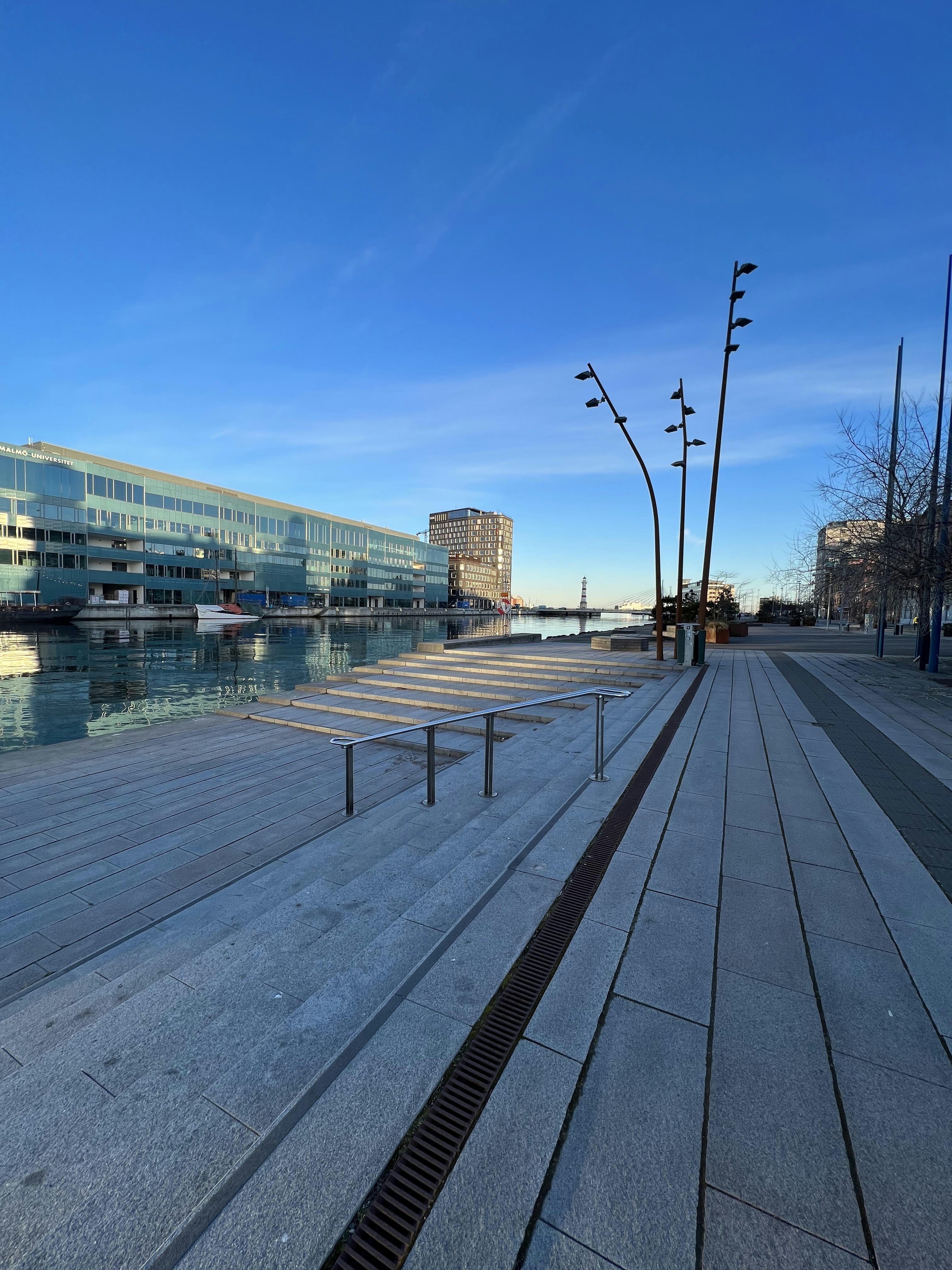 an empty boardwalk next to a body of water