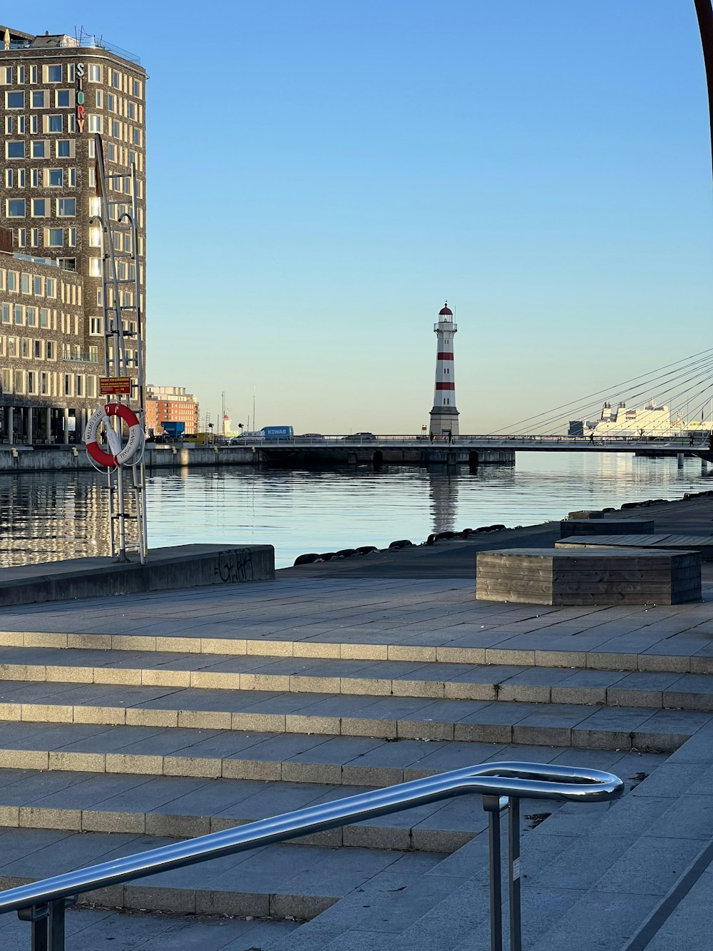 a view of a harbor with a lighthouse in the distance