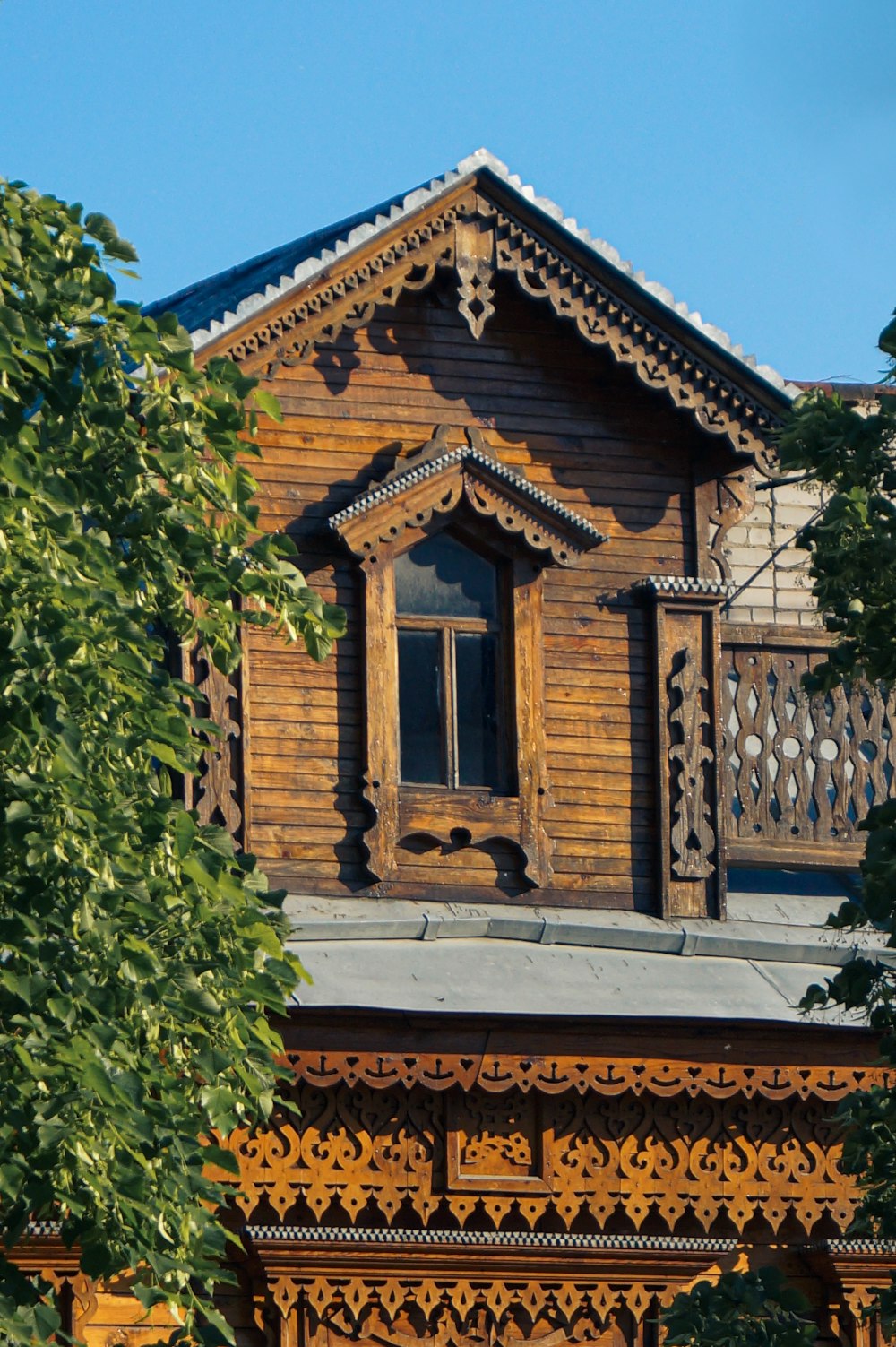 a wooden building with a clock on the front of it