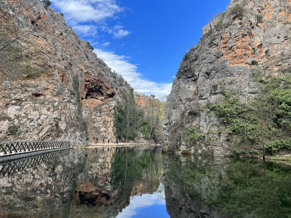 a body of water surrounded by mountains and trees