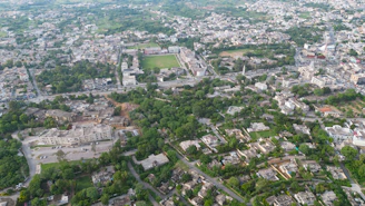 Aerial view of a city with planned urban development and green spaces.