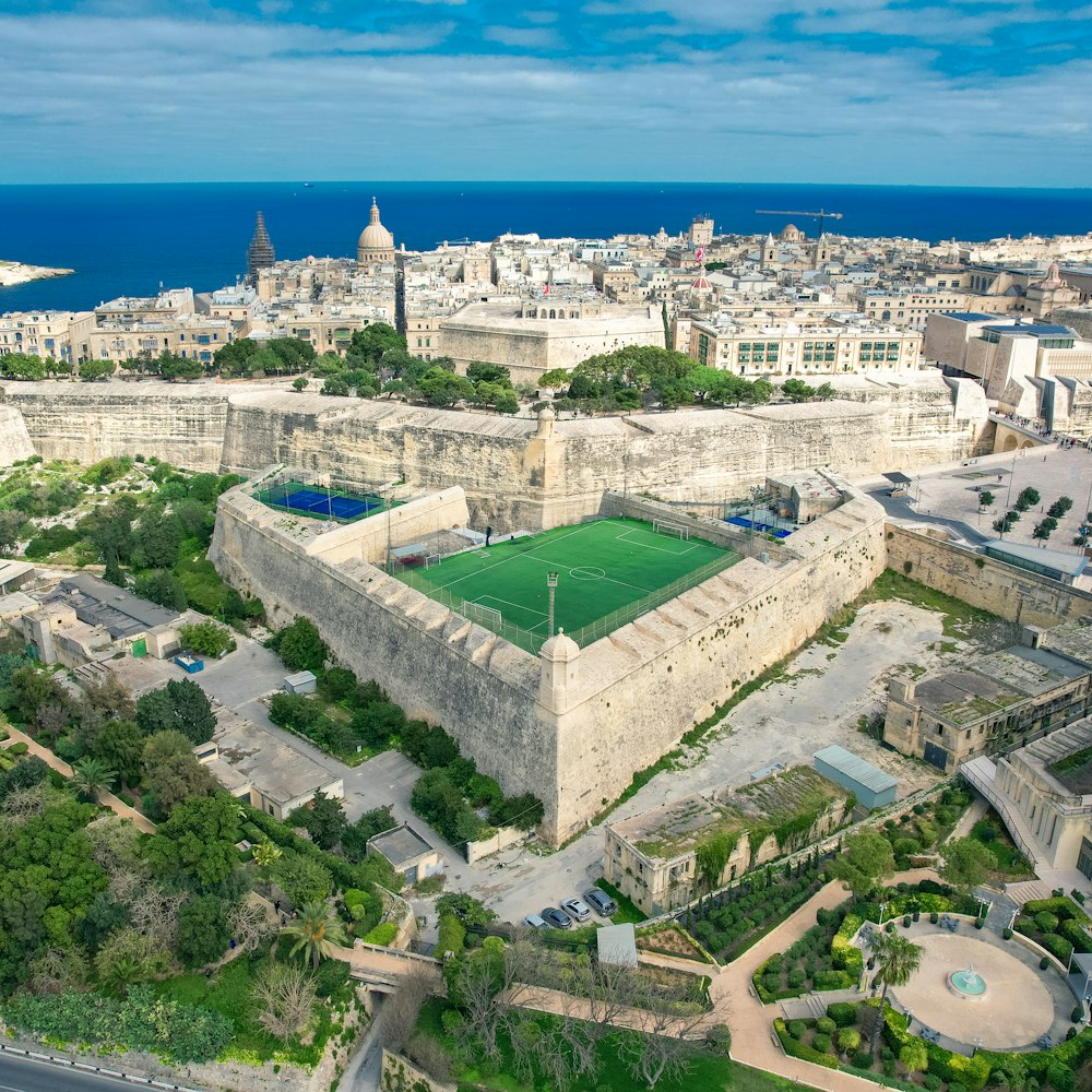 an aerial view of a city with a soccer field