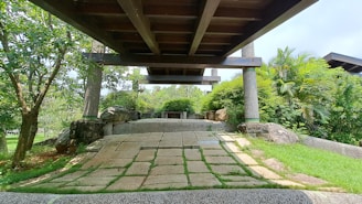 Outdoor pathway paved with smooth granite cubes surrounded by greenery.