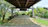 A beautifully tiled garden pathway with weather-resistant outdoor tiles surrounded by greenery.