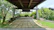 A beautifully tiled garden pathway with weather-resistant outdoor tiles surrounded by greenery.