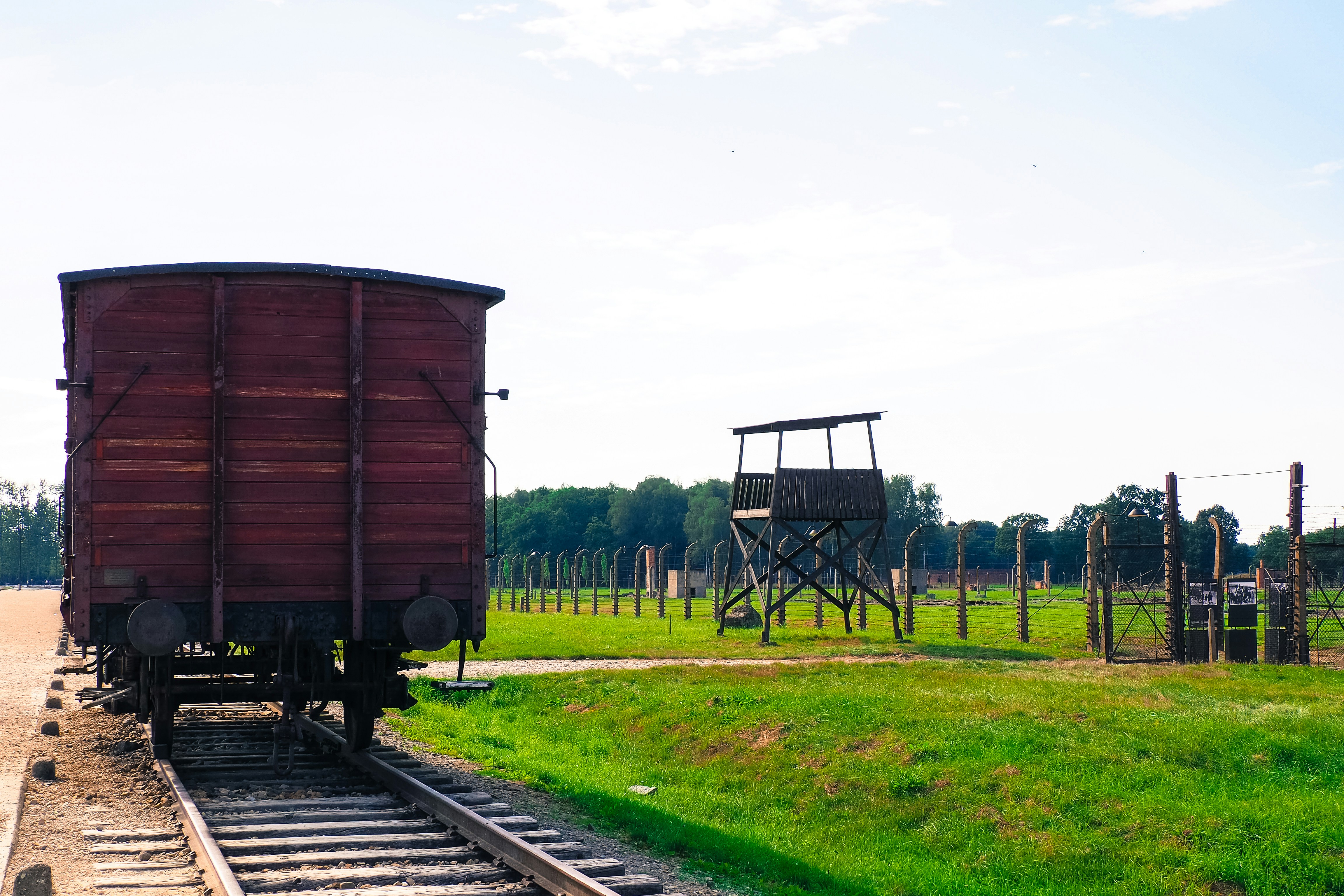 a train car sitting on the tracks in a field