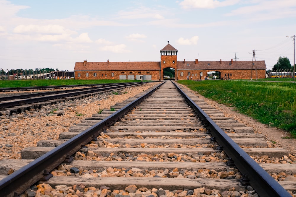 a train track with a building in the background