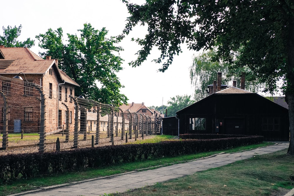 a fenced in area next to a row of houses