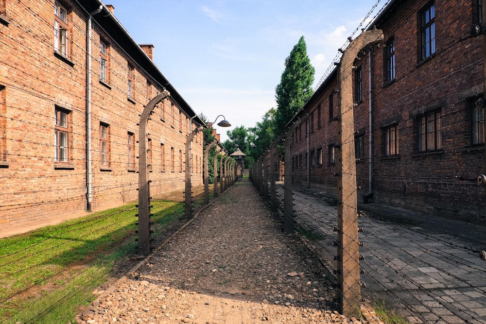 a brick building with a stone walkway between it