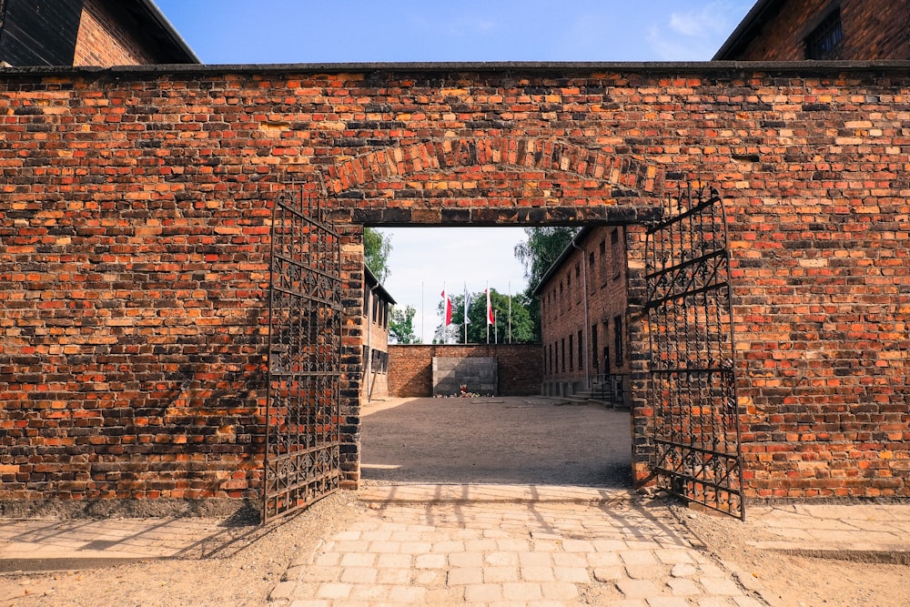 a brick building with a gate and a brick walkway