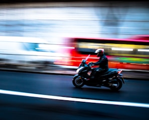 A dynamic shot of a motorcycle speeding on an open road.