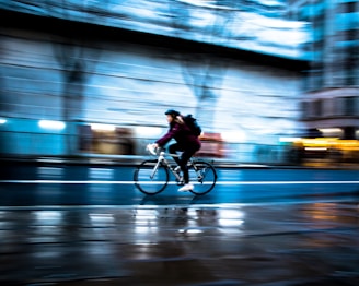 Side view of a cyclist pedaling smoothly with motion blur highlighting efficient form.