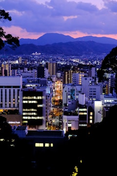 A vibrant purple-hued cityscape at dusk, showcasing dynamic lighting and sharp contrasts.