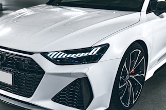 A close-up of a sleek sports car's front grille.