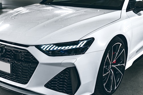 A close-up of a sleek sports car's front grille.