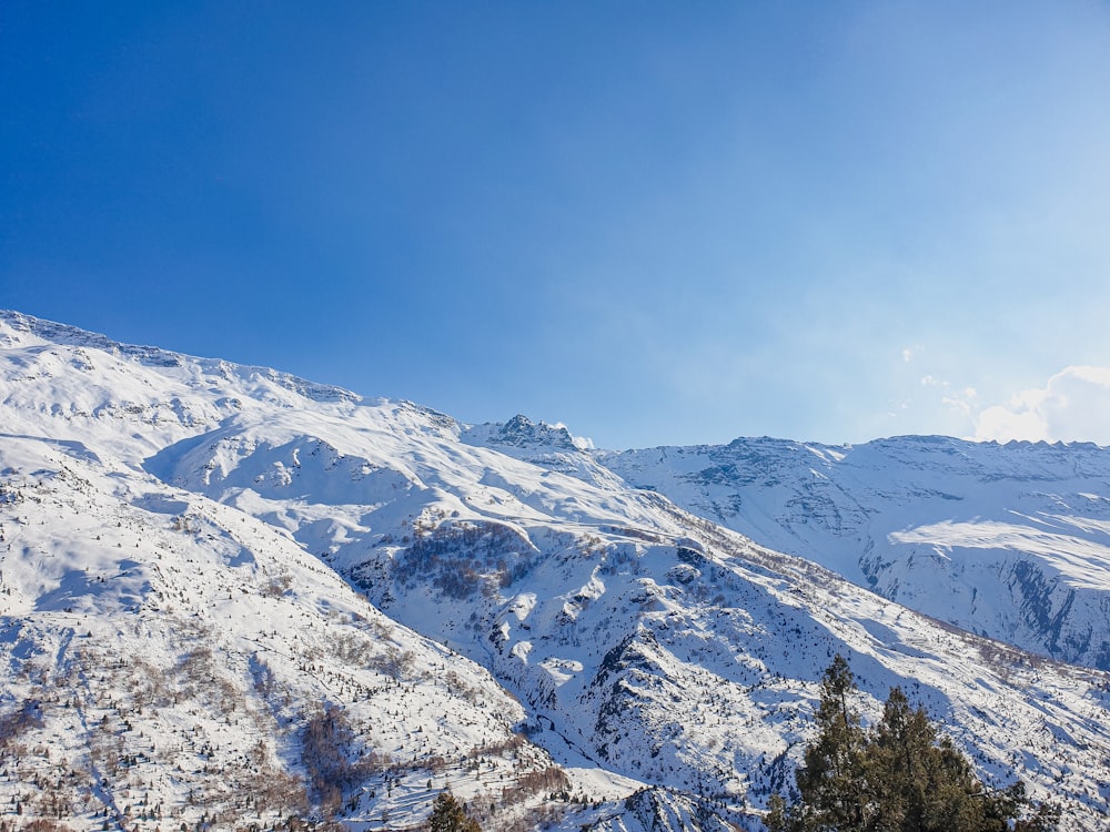 a mountain covered in snow under a blue sky