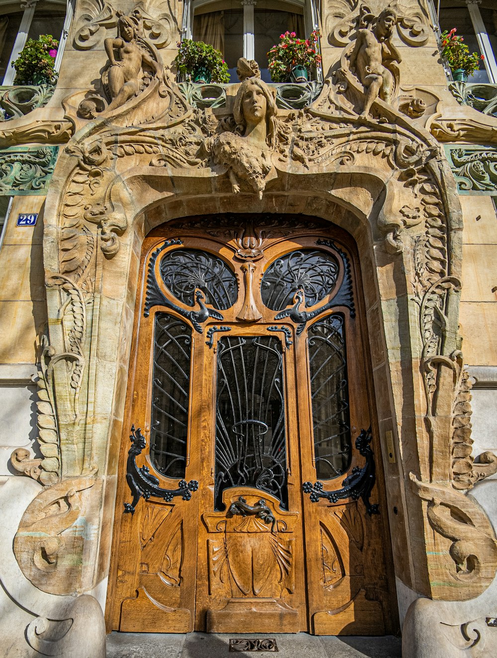 a wooden door with ornate carvings on the side of a building