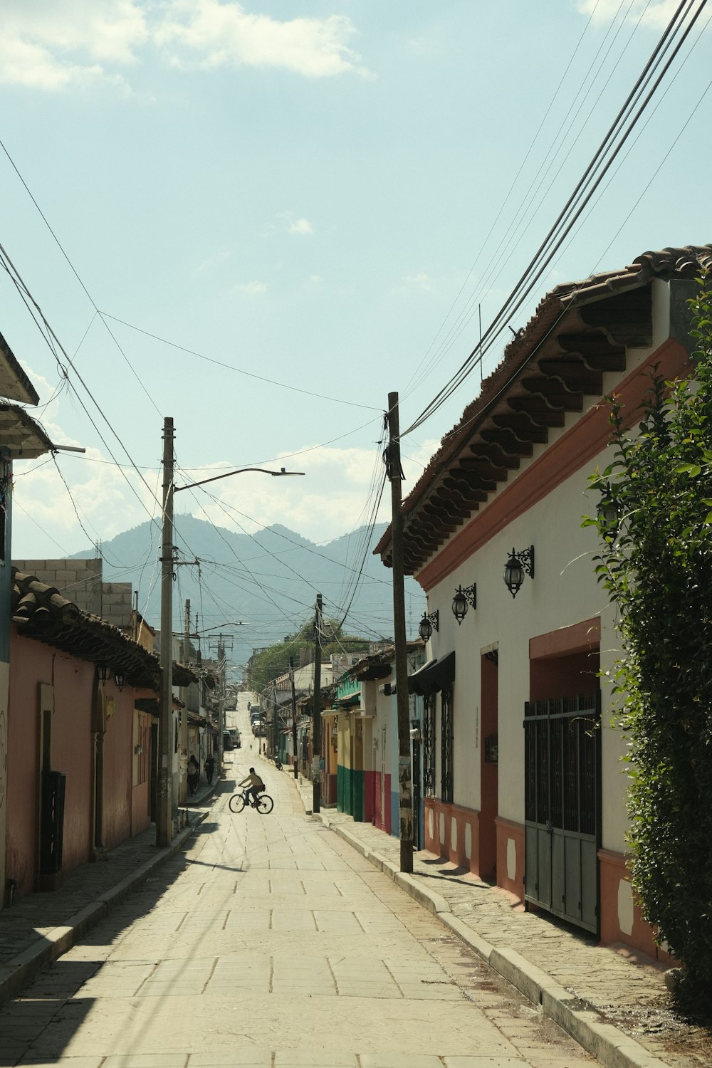 a person riding a bike down a street