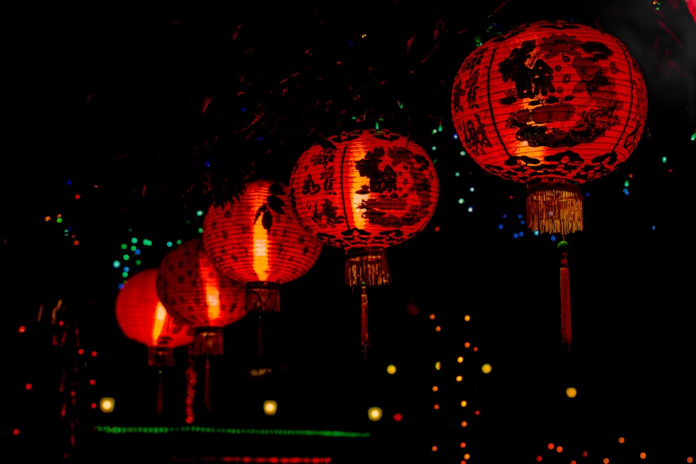 a group of red lanterns lit up in the dark