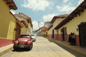 a red car parked on the side of a road