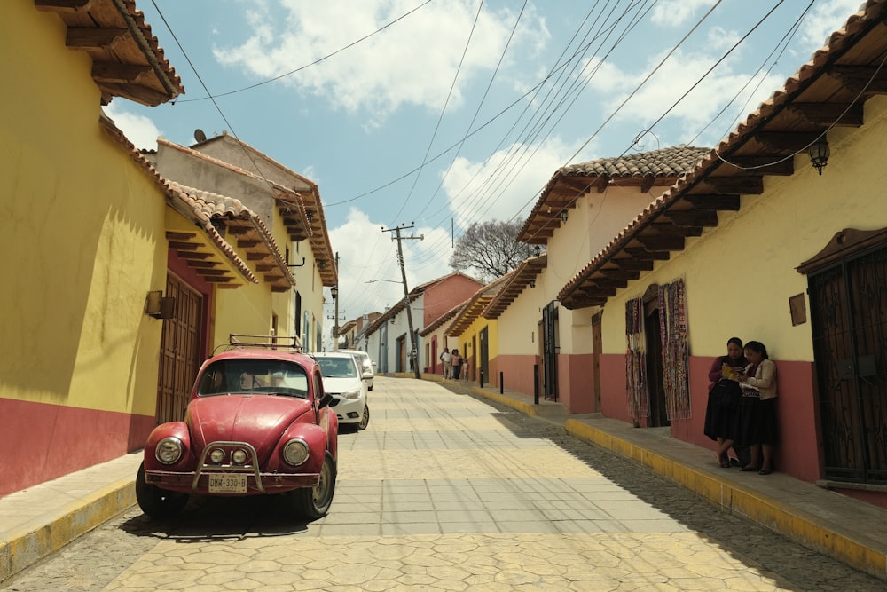 a red car parked on the side of a road