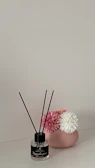 Minimalist vanity setup with elegant perfume bottles and fresh flowers.