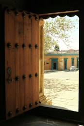 a wooden door is open to a building