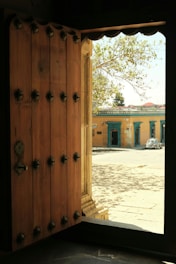 a wooden door is open to a building