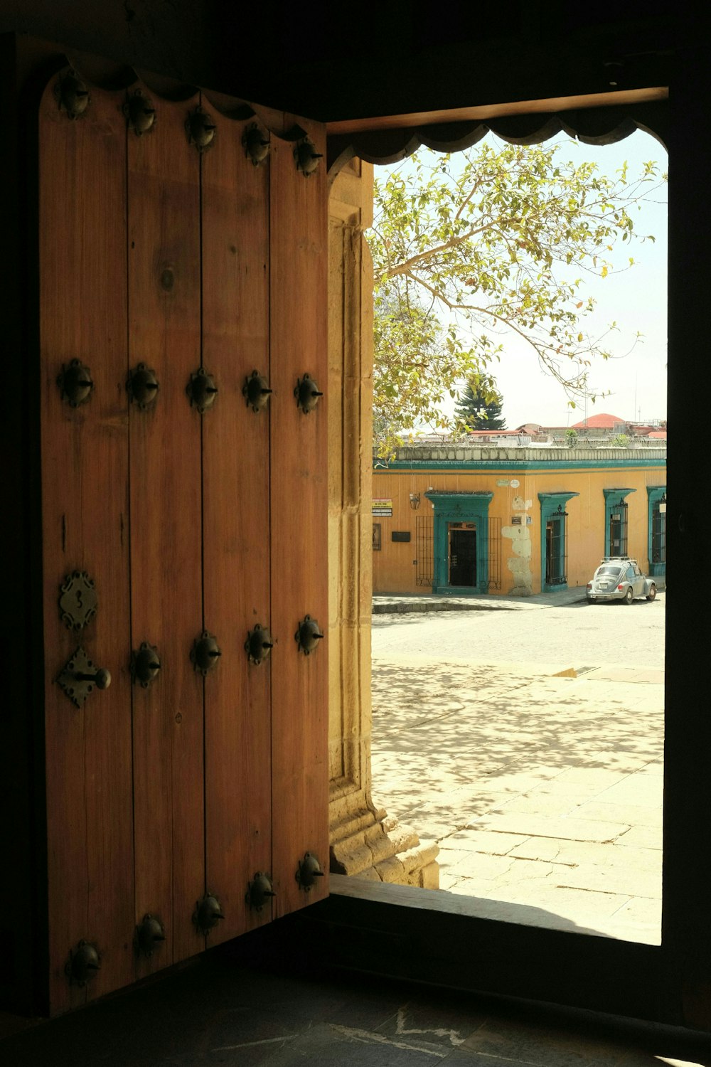 a wooden door is open to a building