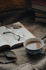 A cozy reading nook with a stack of ebooks and a warm cup of coffee.