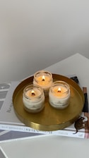 A serene spiritual setting with candles and ancient texts on a wooden table.