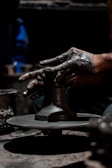 Close-up shot of hands crafting pottery in soft natural light.
