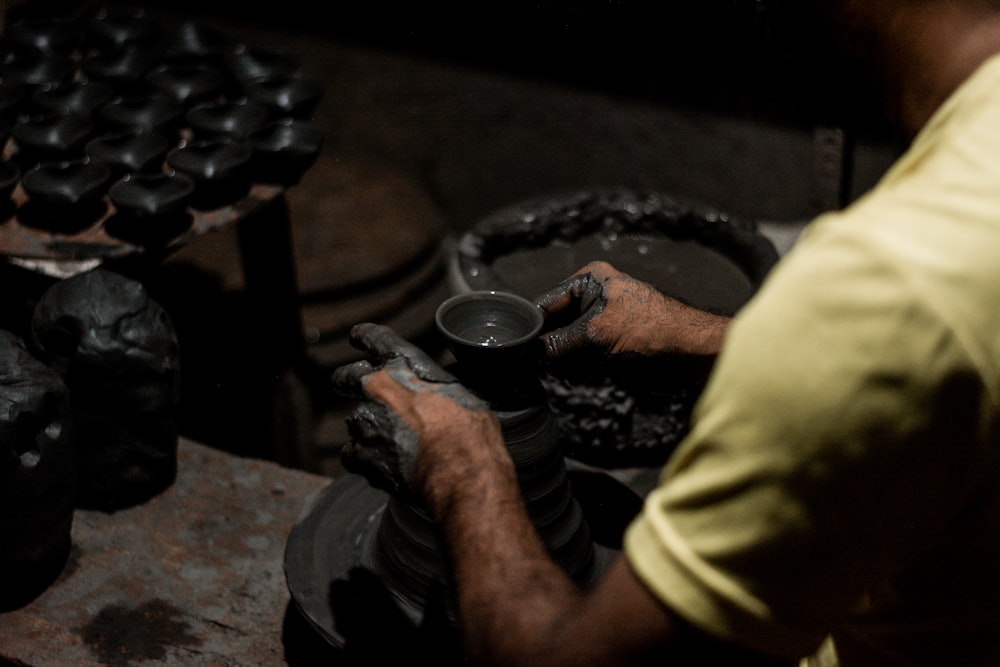 a man working on a wheel in a workshop