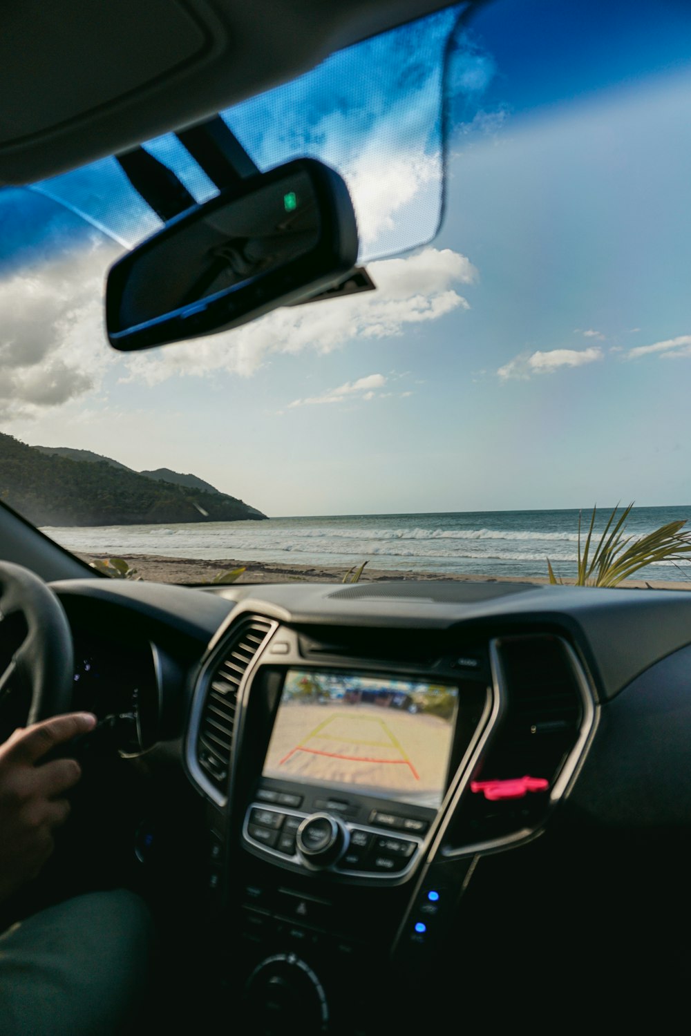 a man driving a car on the beach