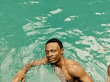 A person relaxing in a bath with clear water.