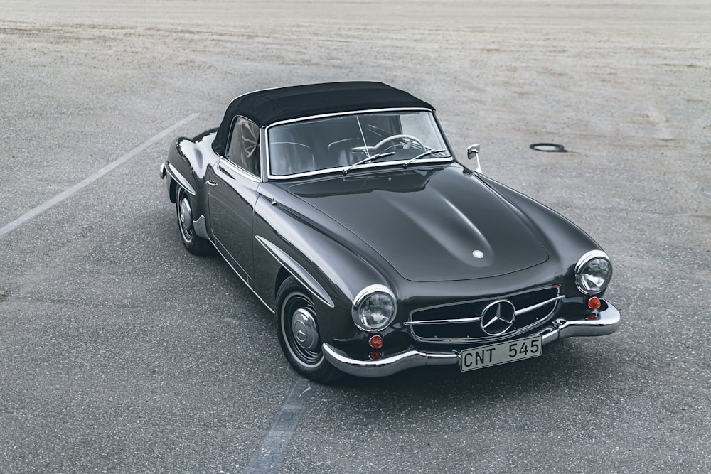 a black mercedes sports car parked in a parking lot