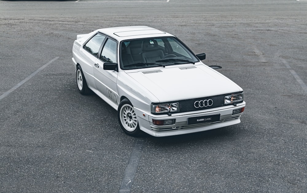 a white car parked in a parking lot